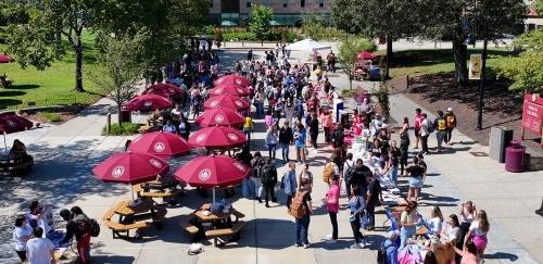 Drone overhead shot of crowded quad during student activities fair